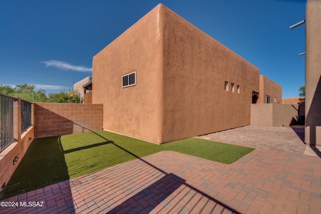 exterior space featuring a lawn and a patio area