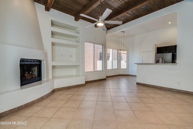 unfurnished living room featuring wood ceiling, built in shelves, ceiling fan, and light tile patterned floors