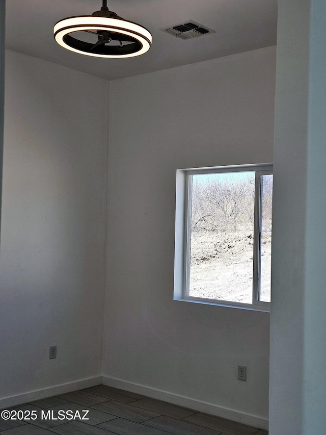 spare room with visible vents and baseboards