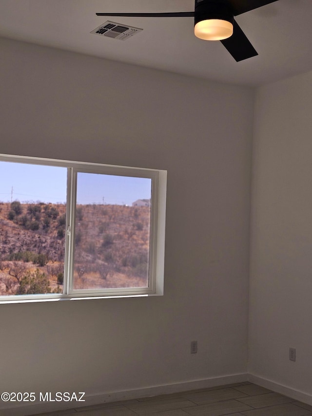 unfurnished room with visible vents and baseboards