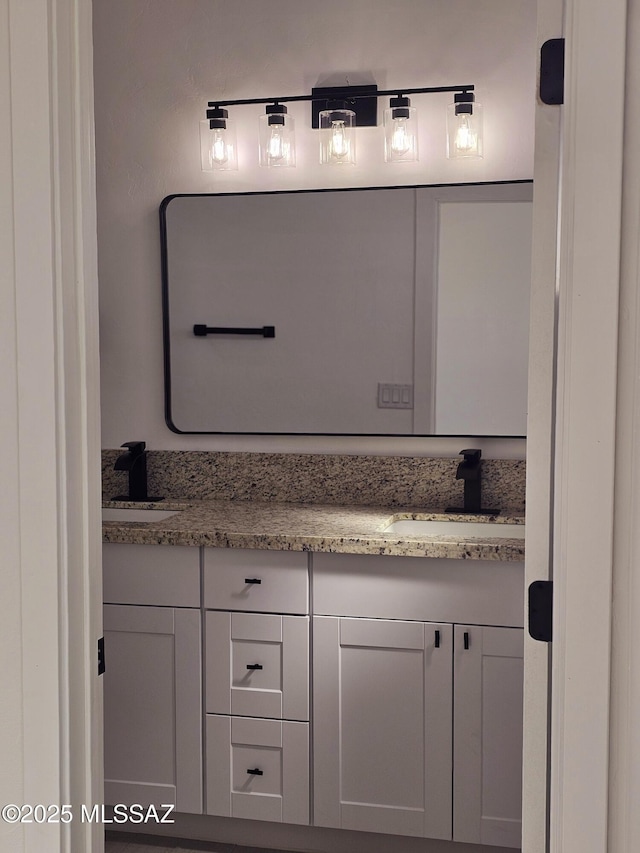 full bath featuring double vanity and a sink