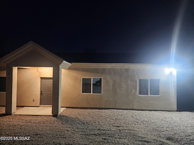 back of property with a patio area and stucco siding