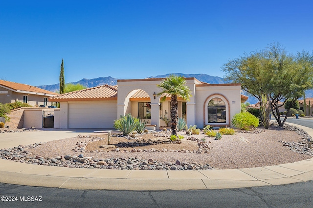 view of front of property with a mountain view and a garage