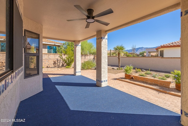 view of patio / terrace with a mountain view and ceiling fan