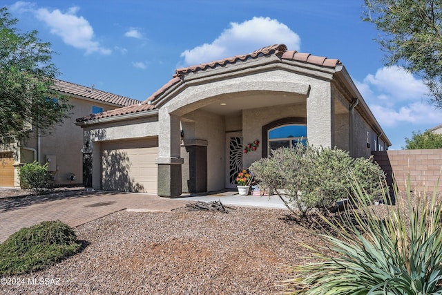 mediterranean / spanish home featuring a garage