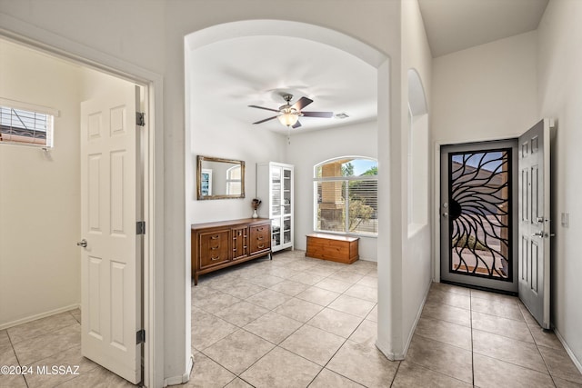 tiled entrance foyer with ceiling fan