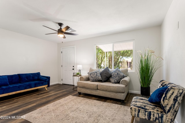 living room with dark wood-type flooring and ceiling fan