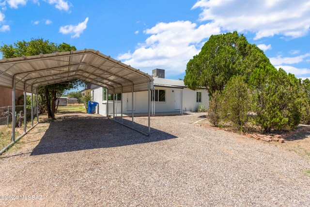 view of vehicle parking with a carport