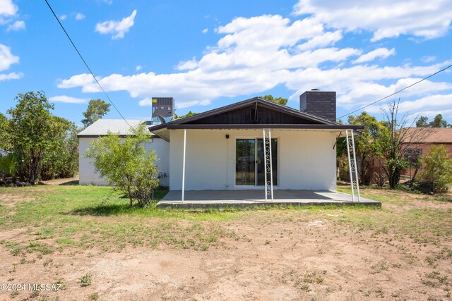 rear view of house with a patio and central AC unit