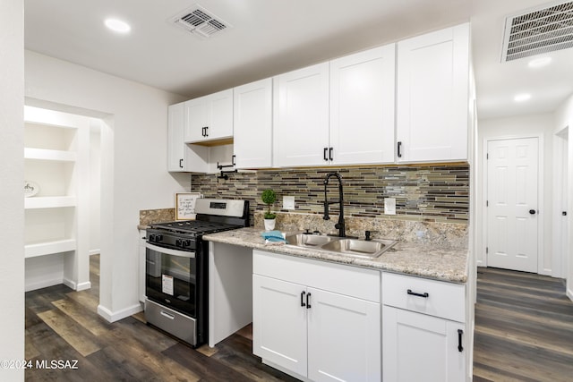 kitchen with sink, dark hardwood / wood-style flooring, stainless steel range with gas cooktop, white cabinets, and decorative backsplash