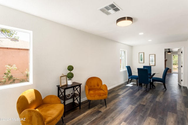 dining space with a wealth of natural light and dark hardwood / wood-style flooring