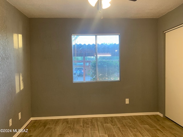 empty room featuring ceiling fan and hardwood / wood-style floors