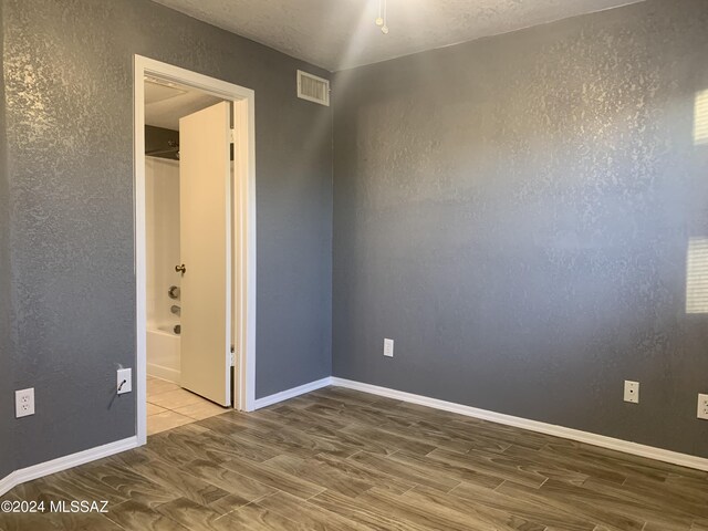 empty room with wood-type flooring