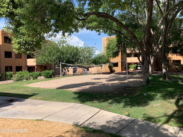 view of home's community featuring a yard and volleyball court