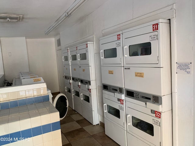 clothes washing area featuring stacked washer and dryer and washer and dryer