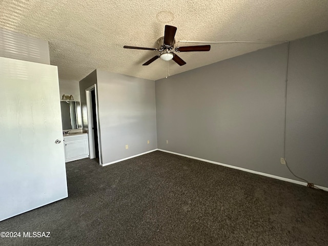 carpeted empty room with a textured ceiling and ceiling fan