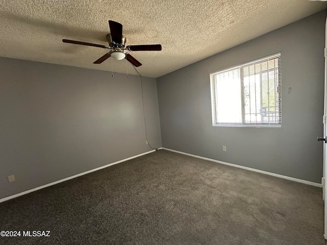 carpeted spare room with a textured ceiling and ceiling fan