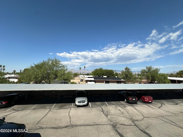 view of parking / parking lot with a carport