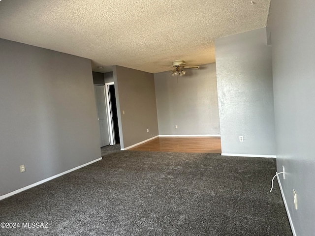 empty room with ceiling fan, a textured ceiling, and carpet flooring