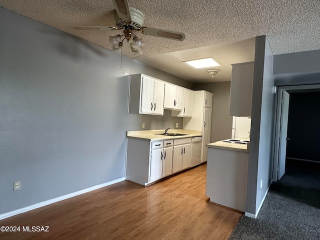 kitchen featuring ceiling fan, white cabinets, light hardwood / wood-style flooring, and sink