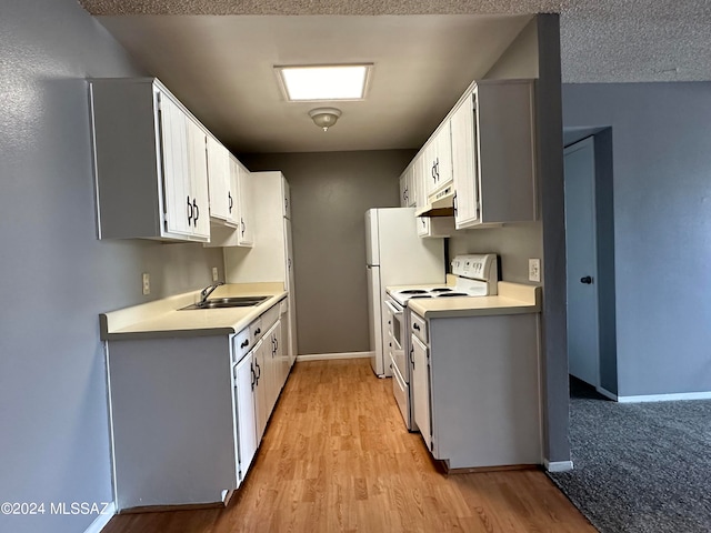 kitchen featuring light wood-type flooring, white cabinetry, electric range, and sink