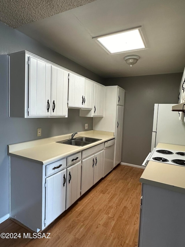 kitchen featuring sink, white appliances, white cabinetry, exhaust hood, and light wood-type flooring