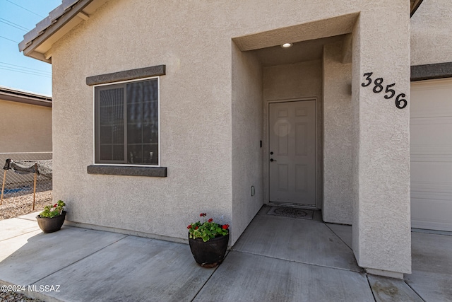 doorway to property with a garage