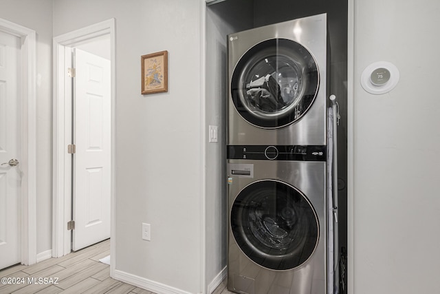 washroom featuring light wood-type flooring and stacked washer and dryer