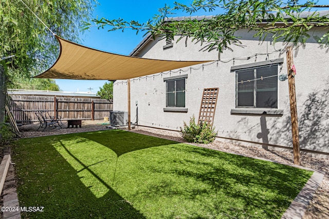 rear view of house with a lawn and a patio area