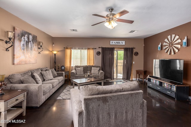 living room with dark hardwood / wood-style flooring and ceiling fan