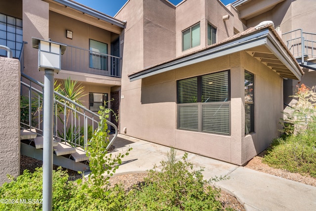 view of side of home with a balcony