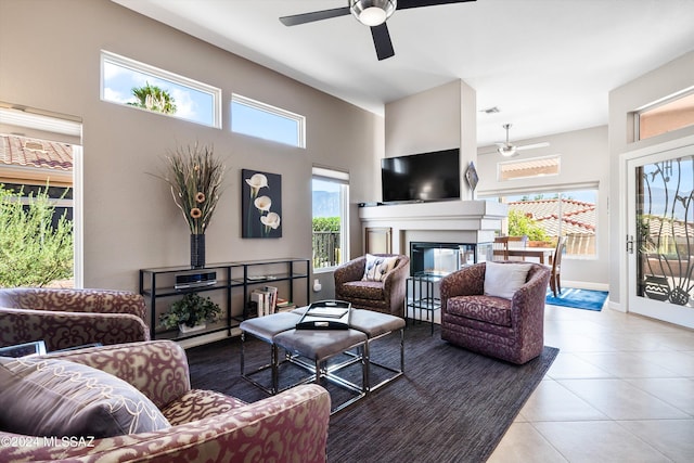 living room with ceiling fan and light tile patterned floors