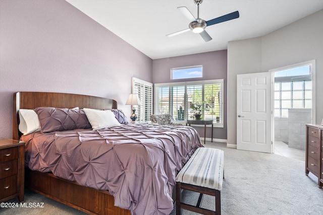 carpeted bedroom featuring ceiling fan and ensuite bath