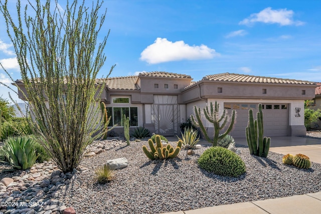 mediterranean / spanish house featuring a garage