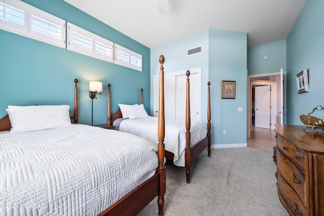 bedroom with ceiling fan and light carpet