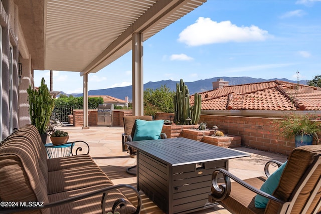 view of patio / terrace featuring a mountain view and exterior kitchen