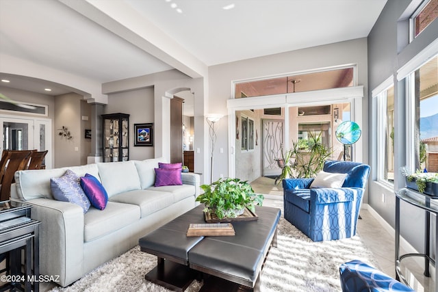 living room with decorative columns and a healthy amount of sunlight