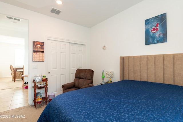 tiled bedroom with a closet