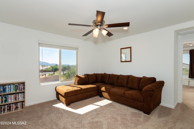 living room featuring a mountain view and light colored carpet