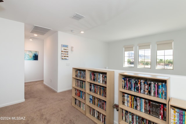 hallway featuring light carpet