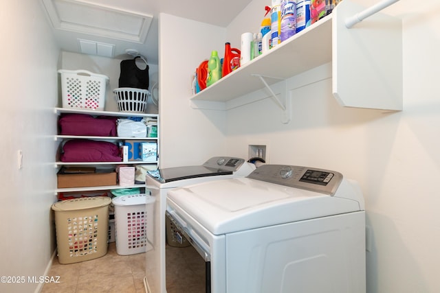 washroom featuring washing machine and clothes dryer and light tile patterned floors