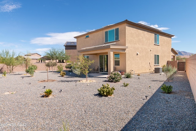 back of house with central air condition unit and a patio area