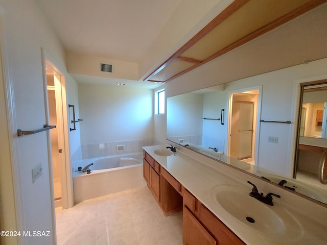 bathroom featuring a tub to relax in and vanity