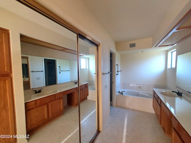 bathroom featuring vanity and a bath