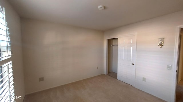 unfurnished bedroom featuring a closet and carpet