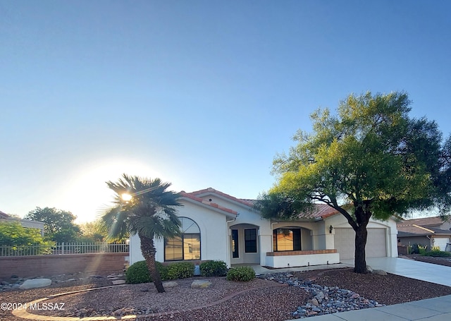 mediterranean / spanish-style home with a garage