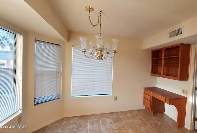 unfurnished dining area with an inviting chandelier and light tile patterned floors