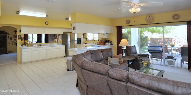 living room featuring ceiling fan and light tile patterned floors