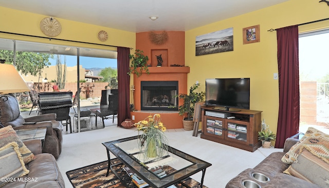 living room with light colored carpet and a fireplace