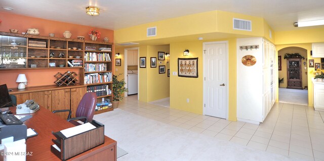 office space featuring light tile patterned floors and washer / dryer